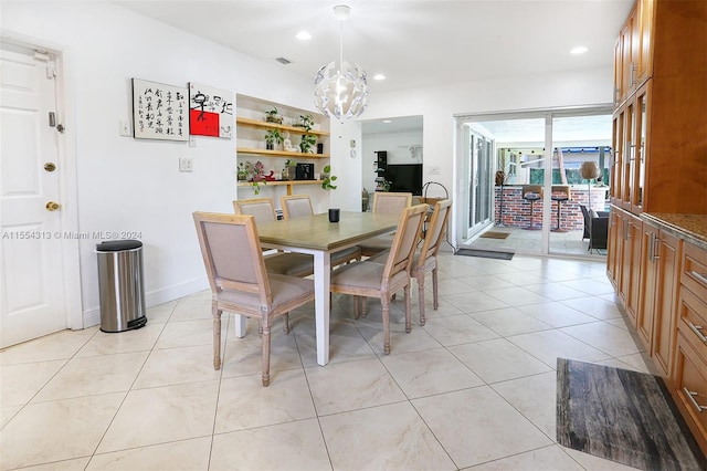 dining space featuring light tile patterned flooring and an inviting chandelier