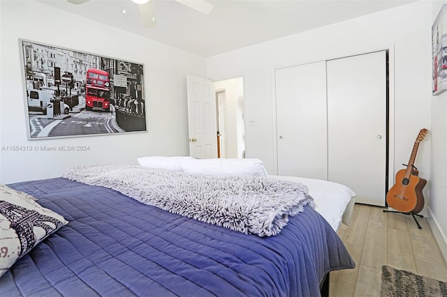 bedroom with a closet, wood-type flooring, and ceiling fan