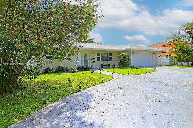 ranch-style house featuring a garage and a front lawn