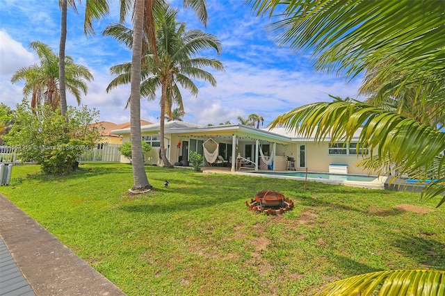 exterior space with a fenced in pool, a patio, and a lawn