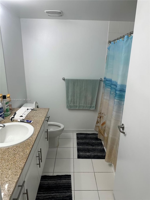 bathroom featuring toilet, vanity, and tile patterned floors