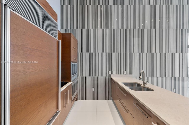 bathroom with tile flooring and sink