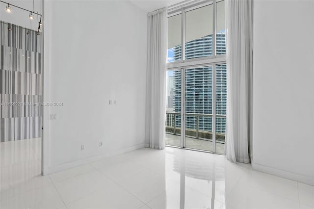 spare room featuring light tile floors