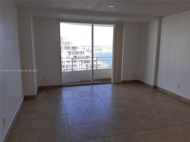 empty room with dark tile floors