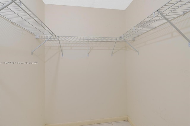 spacious closet featuring tile patterned flooring