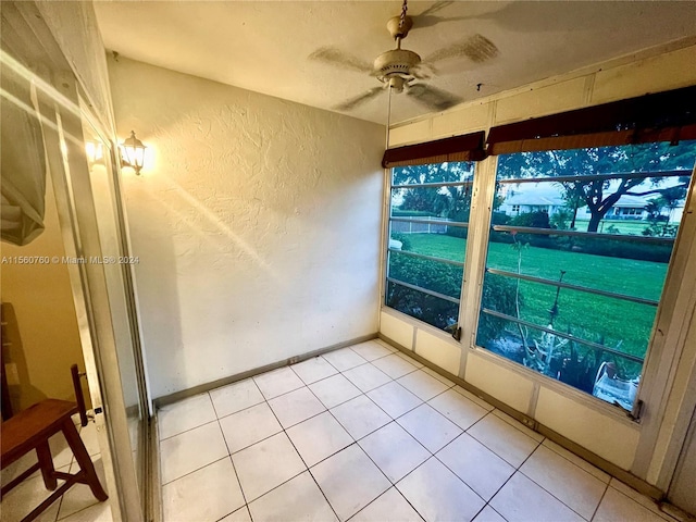 unfurnished sunroom featuring ceiling fan