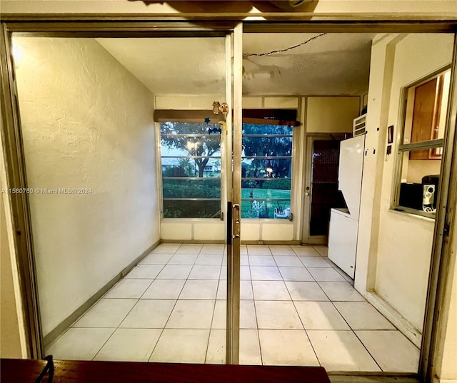 interior space featuring light tile patterned flooring and white refrigerator