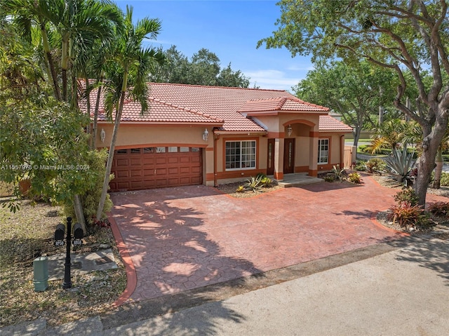 mediterranean / spanish home with a garage