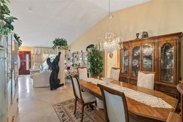 tiled dining space with an inviting chandelier and high vaulted ceiling