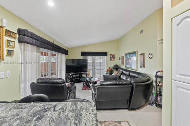 tiled living room with vaulted ceiling