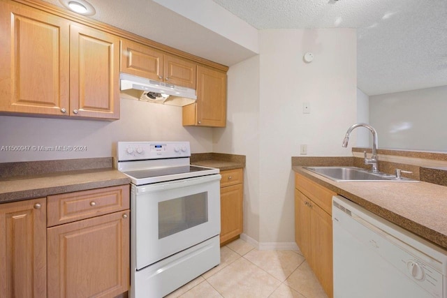 kitchen featuring light brown cabinetry, white appliances, sink, light tile flooring, and a textured ceiling