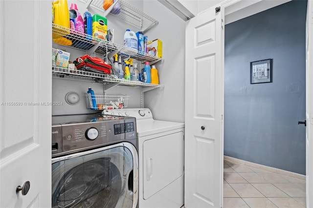 clothes washing area featuring independent washer and dryer and light tile flooring