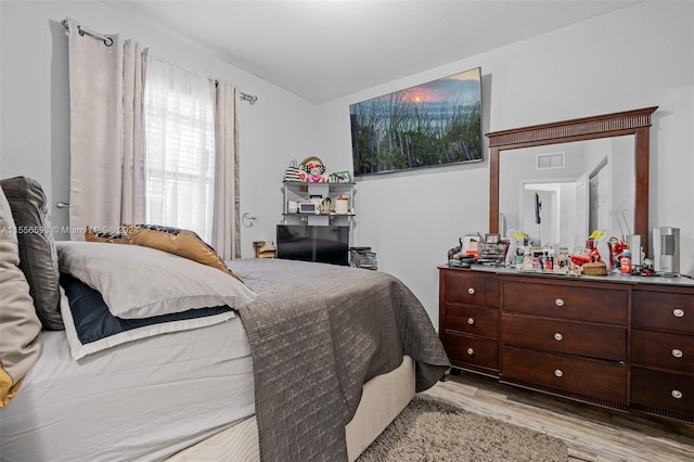 bedroom with light hardwood / wood-style floors