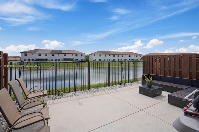 view of patio featuring a water view and an outdoor living space