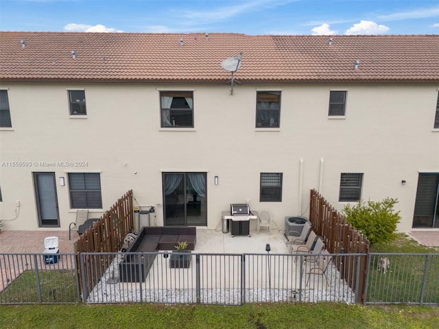 rear view of property with central air condition unit and a patio