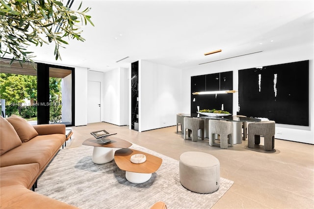 tiled living room featuring expansive windows