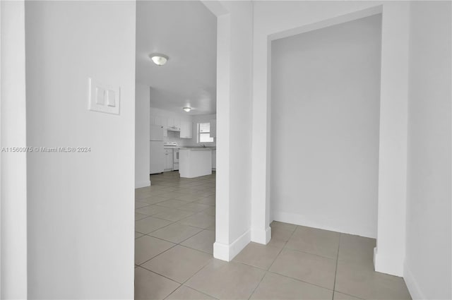 hallway featuring light tile floors