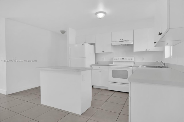 kitchen featuring white appliances, sink, a kitchen island, white cabinets, and light tile flooring