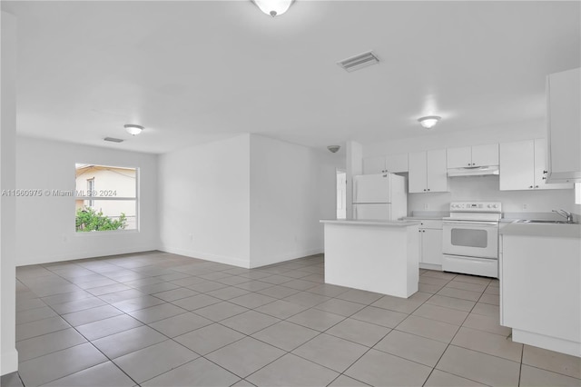 kitchen with light tile flooring, white appliances, sink, white cabinets, and a center island