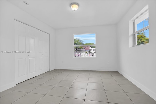 tiled spare room with a wealth of natural light