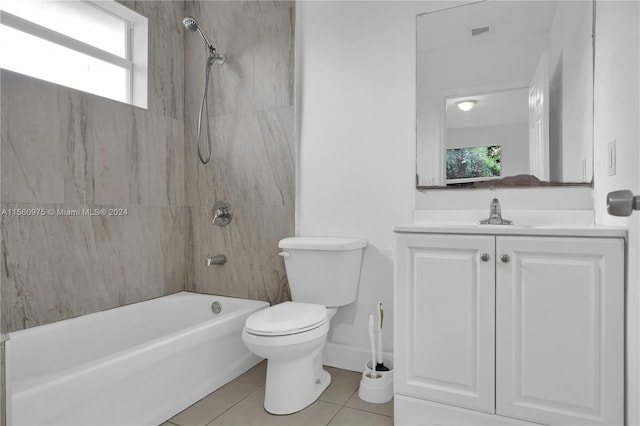 full bathroom featuring toilet, vanity, tile flooring, and tiled shower / bath