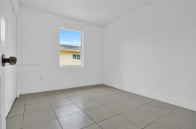 unfurnished room featuring light tile floors