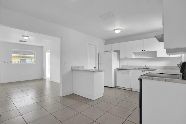 kitchen featuring sink, white appliances, light tile floors, and white cabinets