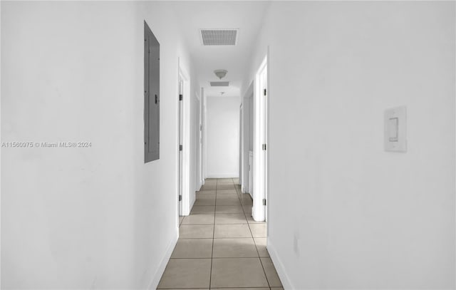 hall featuring light tile flooring