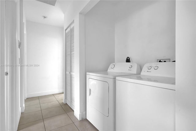 laundry room with independent washer and dryer, light tile floors, and hookup for a washing machine