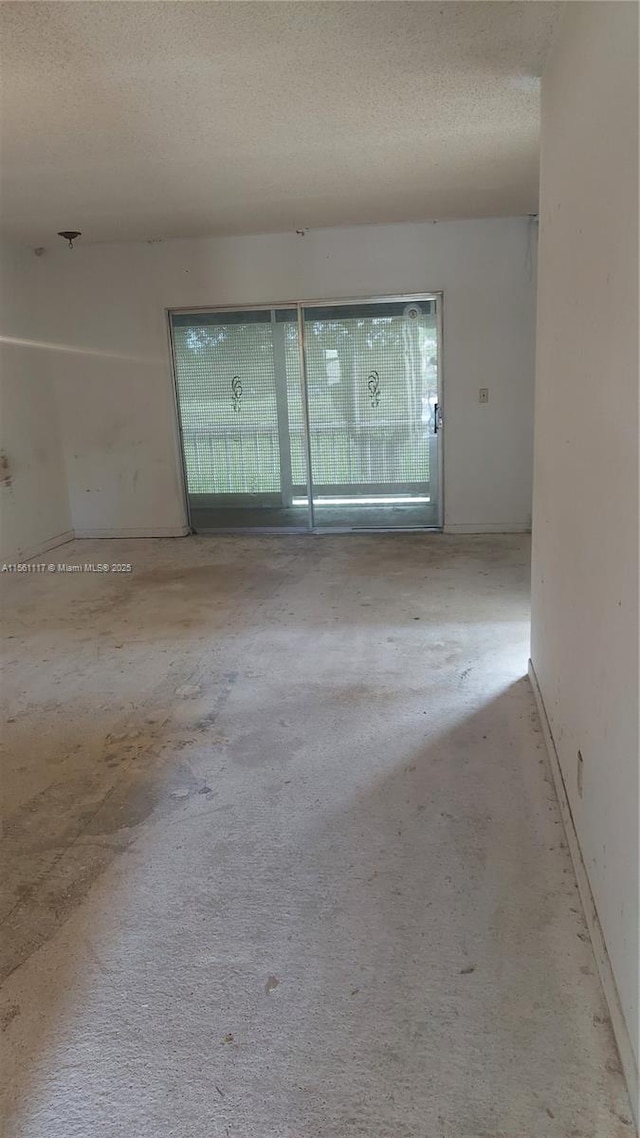 unfurnished room featuring a textured ceiling