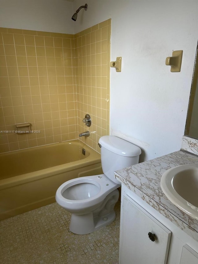 full bathroom featuring vanity, tile patterned floors, toilet, and tiled shower / bath