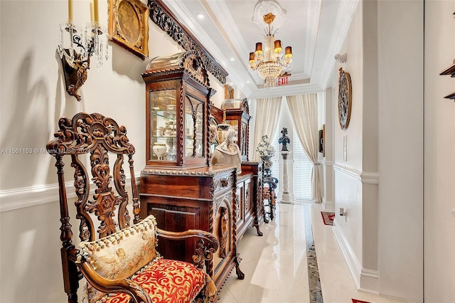 hallway featuring light tile floors, a raised ceiling, a notable chandelier, and crown molding