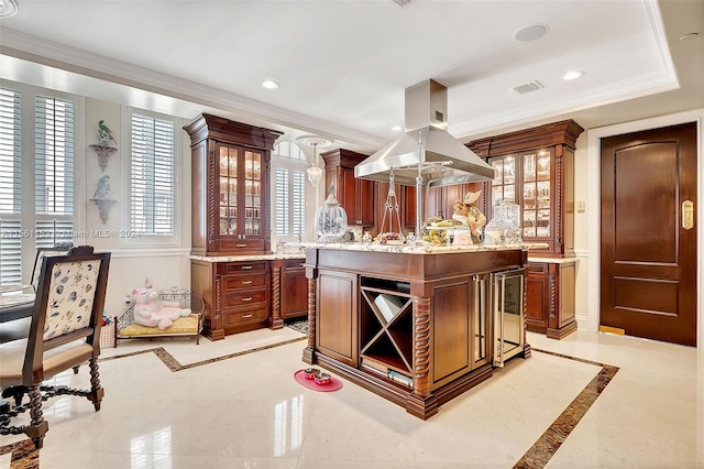 kitchen featuring light tile floors, a kitchen island, a tray ceiling, island exhaust hood, and light stone counters