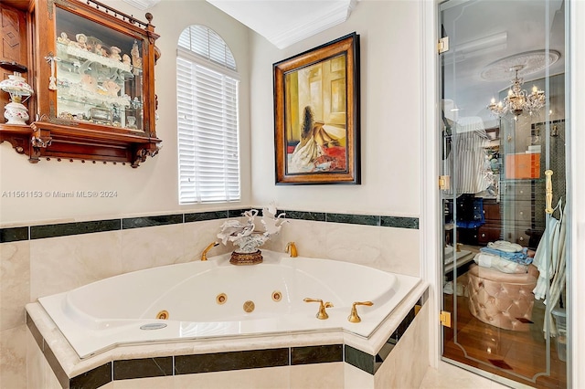 bathroom featuring a relaxing tiled bath, crown molding, tile floors, and an inviting chandelier