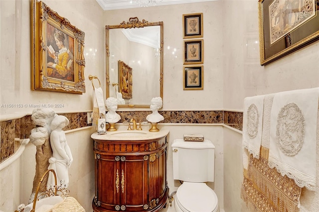 bathroom with vanity, crown molding, and toilet