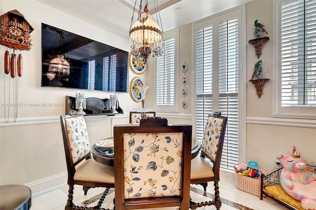 dining room featuring an inviting chandelier and light tile flooring