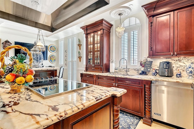 kitchen with backsplash, a tray ceiling, decorative light fixtures, and stainless steel dishwasher