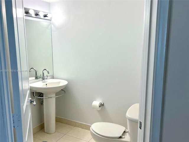 bathroom with tile floors and toilet