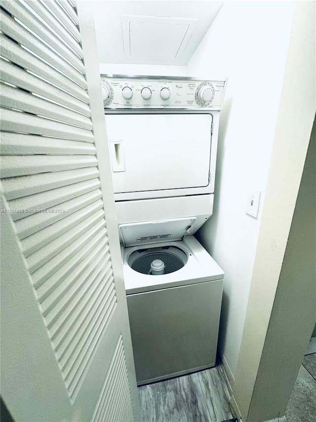 laundry room featuring light wood-type flooring and stacked washer and dryer