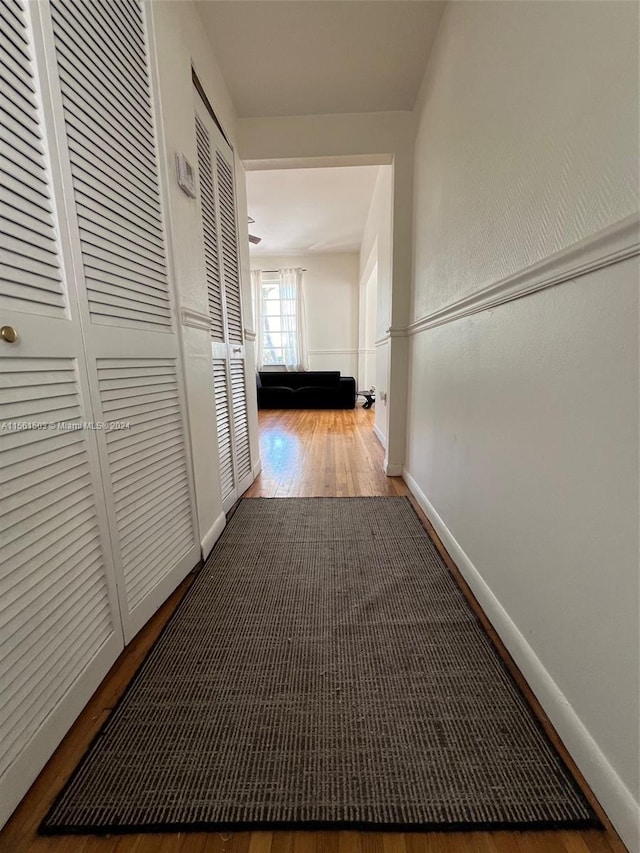 corridor featuring wood-type flooring