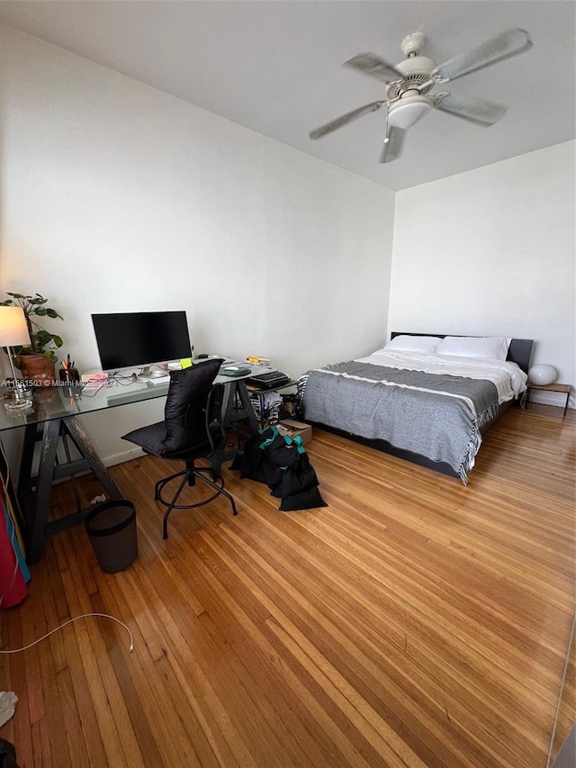 bedroom with hardwood / wood-style floors and ceiling fan