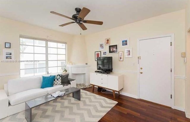 living room featuring dark hardwood / wood-style floors and ceiling fan