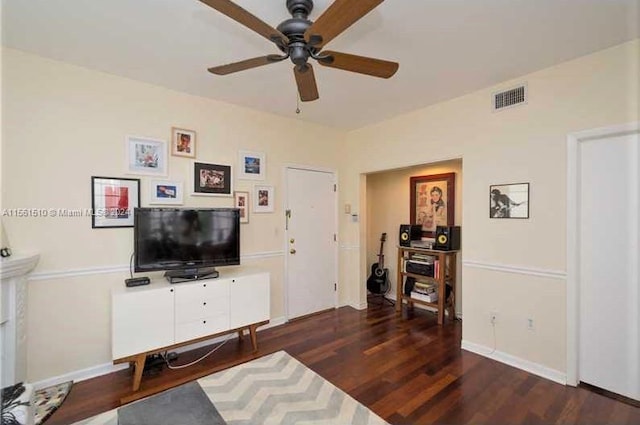 living room with ceiling fan and dark wood-type flooring