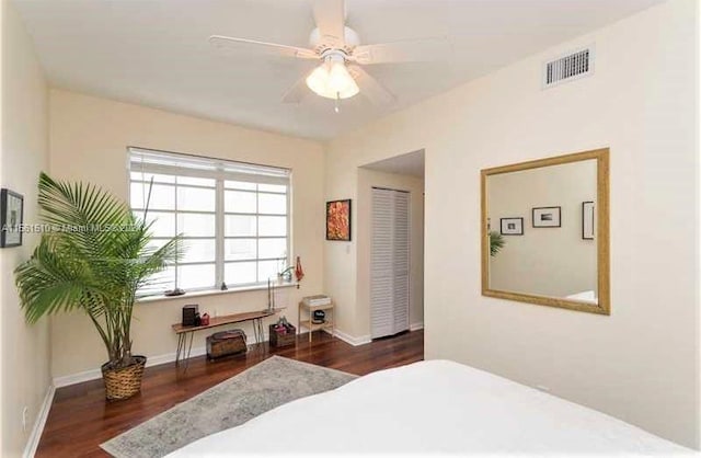 bedroom with a closet, ceiling fan, and dark wood-type flooring