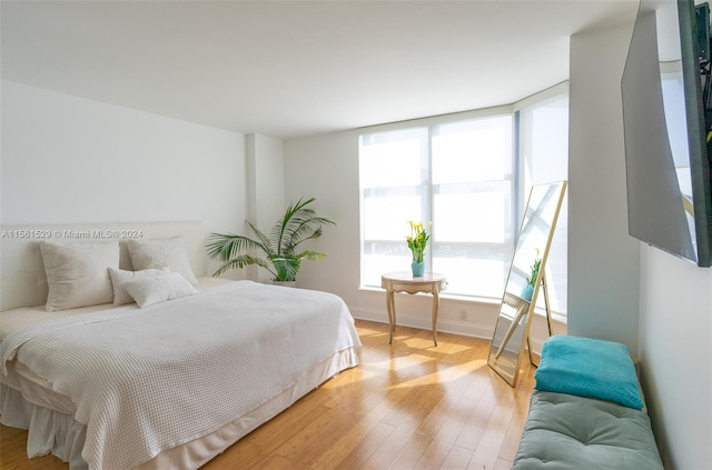 bedroom with hardwood / wood-style flooring