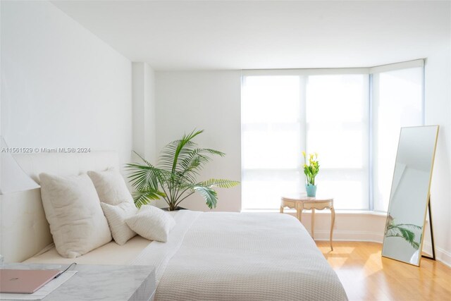 bedroom with hardwood / wood-style flooring