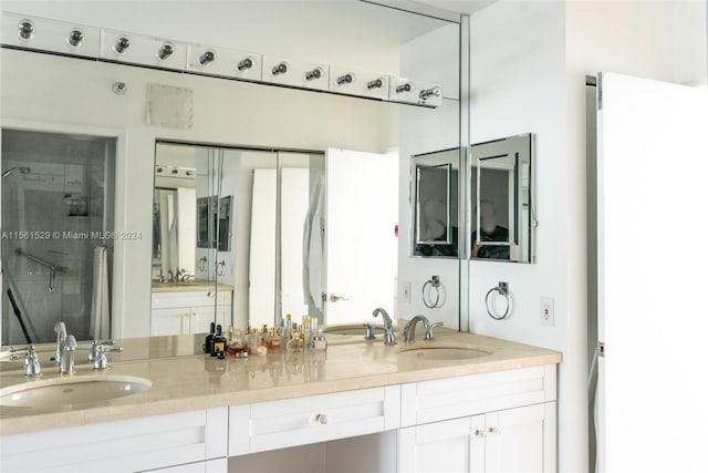 bathroom with double vanity and walk in shower