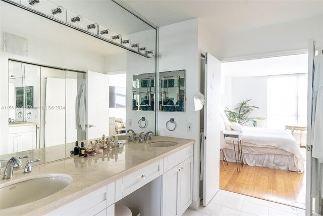 bathroom with tile patterned flooring and dual bowl vanity