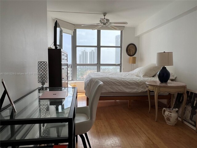 bedroom with wood-type flooring and ceiling fan