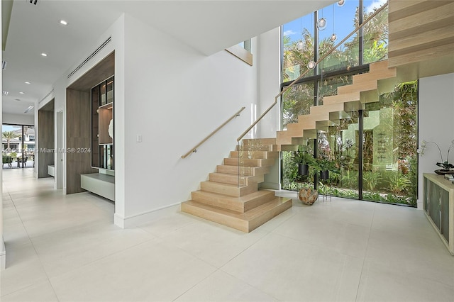 stairway with tile patterned flooring